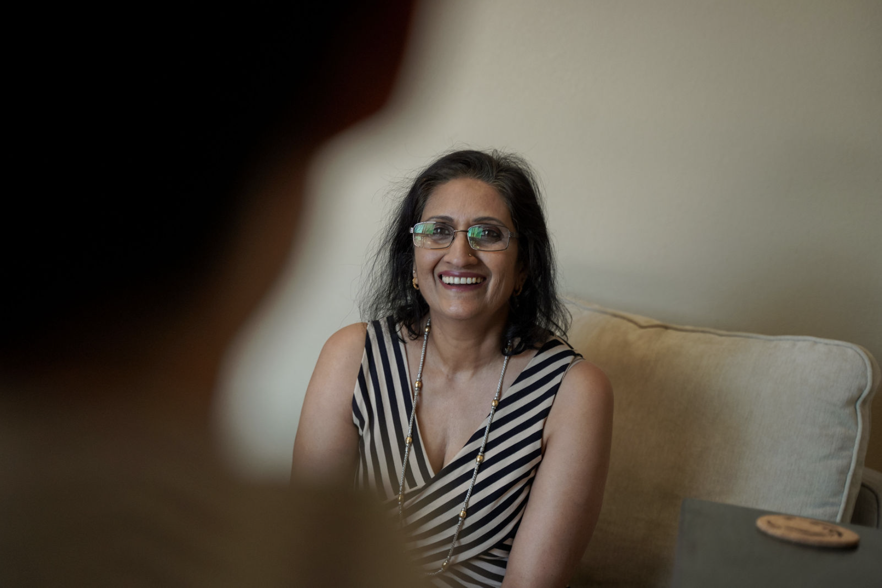 Sujatha smiling warmly during a therapy session at Ayumind